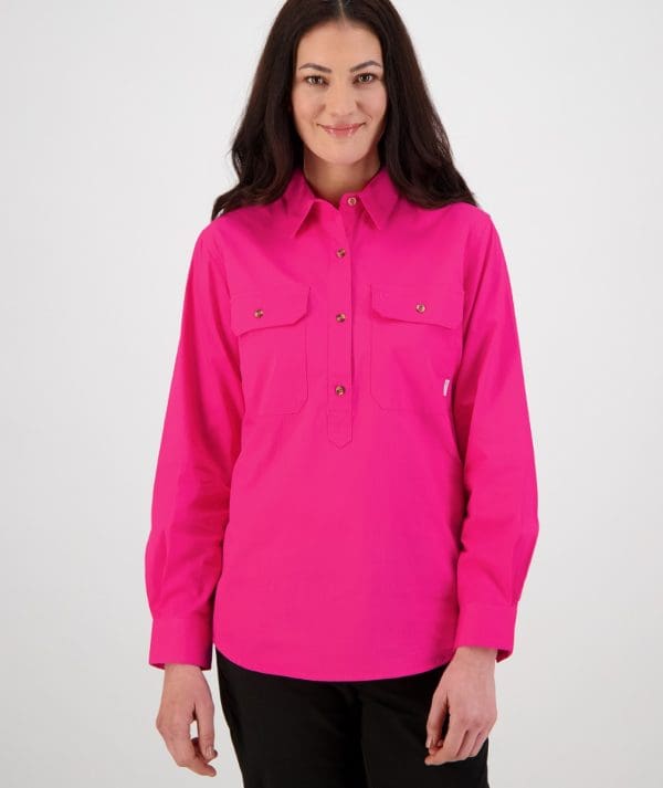 woman standing front on wearing swanndri's women's-roma-long-sleeve-shirt in bright pink. 100% cotton, 152gsm Button flap chest pockets Half placket button opening Centre back box pleat