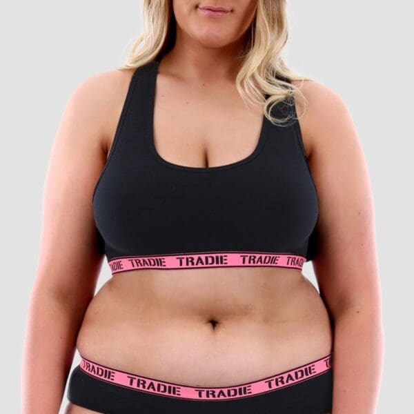 Image of size 18 model wearing Tradie Lady Curve Crop Top. It is black with a pink elastic.