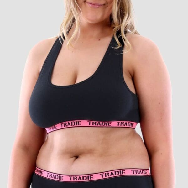 Image of size 18 model wearing Tradie Lady Curve Crop Top. It is black with a pink elastic.