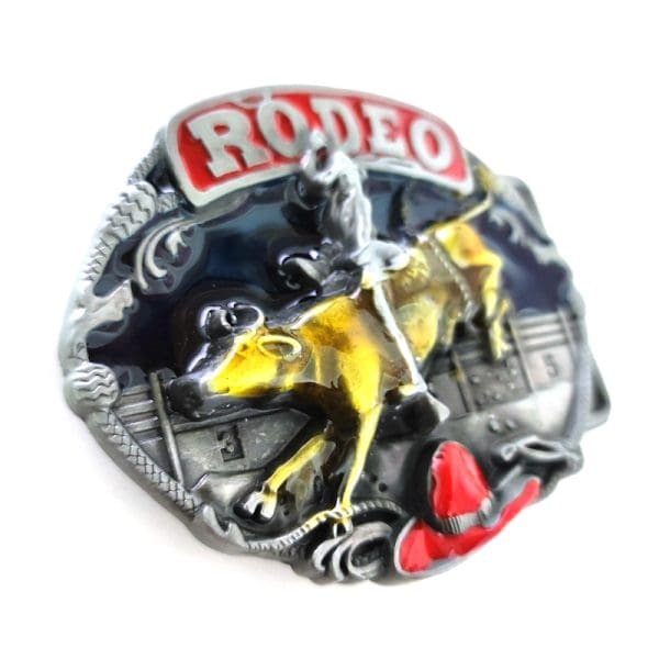 Rodeo Belt Buckle featuring a bucking bull with cowboy rider in the ring on a round belt buckle with black enamel background and accented with a red cowboy hat and red banner inscribed with silver RODEO.